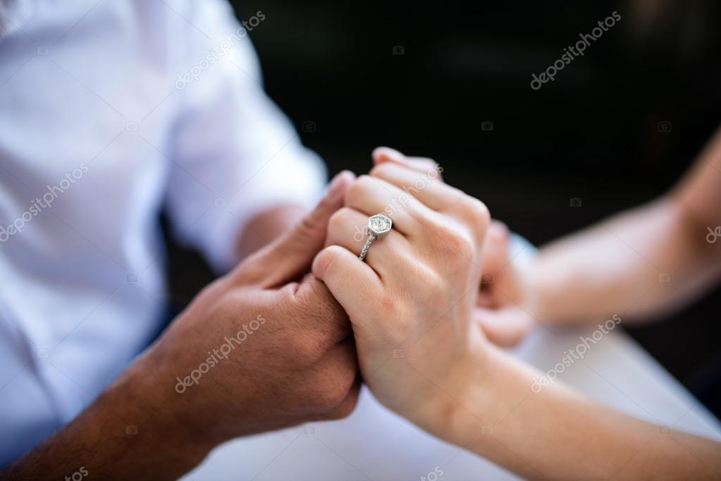 depositphotos 103289900 stock photo couple holding hands with engagement