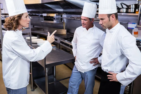 Upset head chef talking to team — Stock Photo, Image