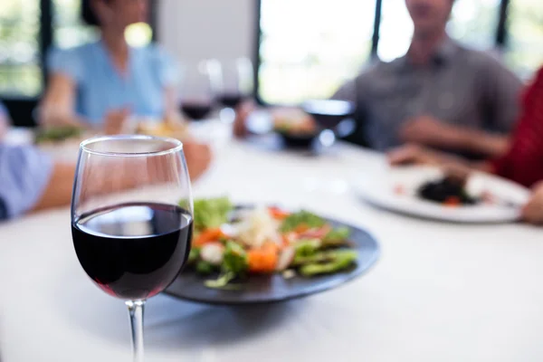 Glass of red wine on restaurant table — Stock Photo, Image