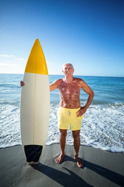 Senior man posing with a surfboard — Stock Photo, Image