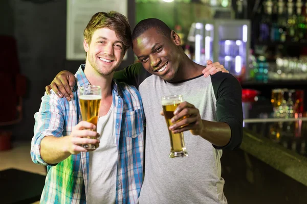 Happy friends having a drink — Stock Photo, Image