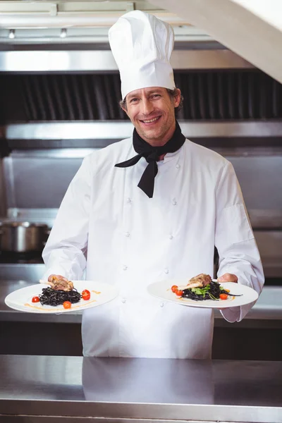 Chef showing plates of spaghetti — Stock Photo, Image