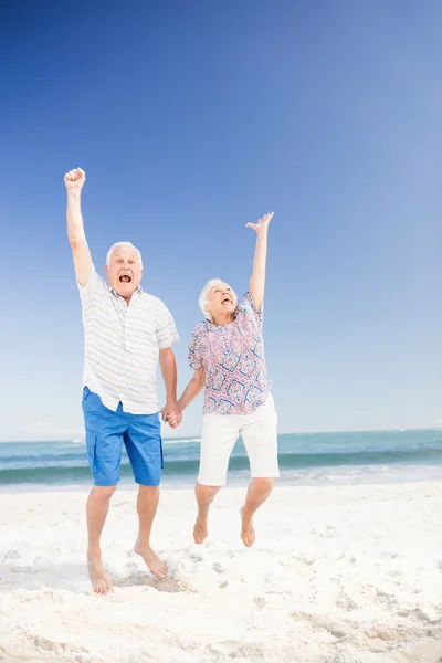 Smiling senior couple jumping — Stock Photo, Image