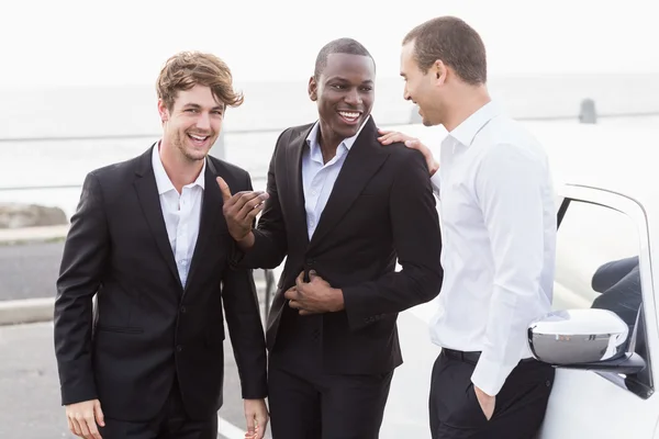 Well dressed people posing next to a limousine — Stock Photo, Image