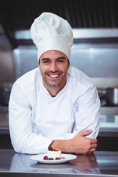 Chef apoyado en el mostrador con un postre — Foto de Stock