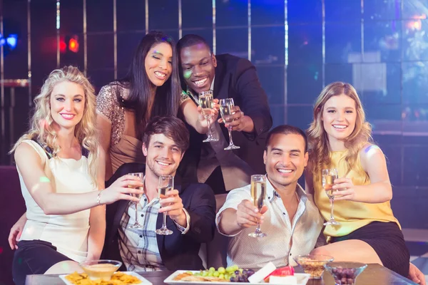 Friends with champagne and snacks — Stock Photo, Image