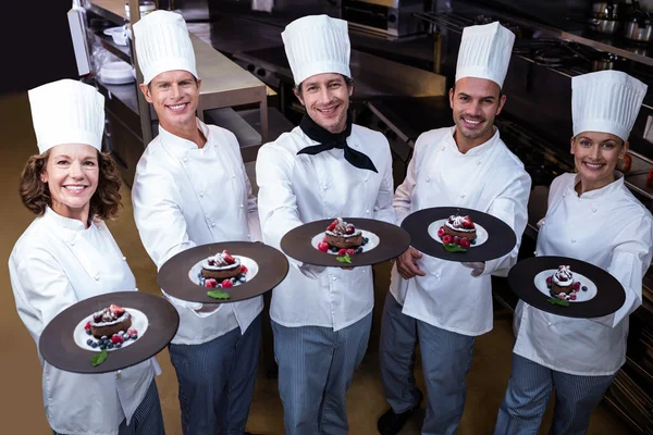 Chefs presenting dessert plates — Stock Photo, Image