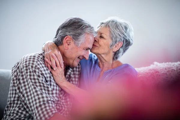 Senior woman embracing and kissing on mans forehead — Stock Photo, Image
