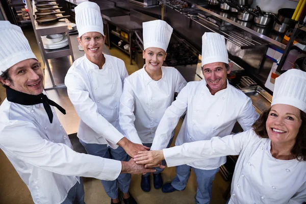 Chefs team putting hands together — Stock Photo, Image