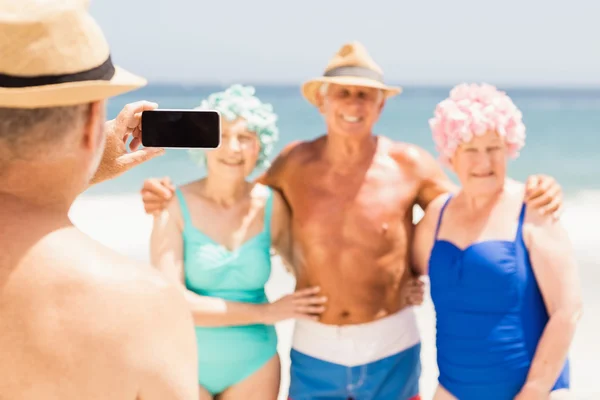 Senior man taking picture of his friends — Stock Photo, Image