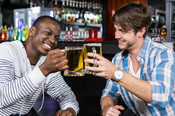Happy friends having a drink — Stock Photo, Image