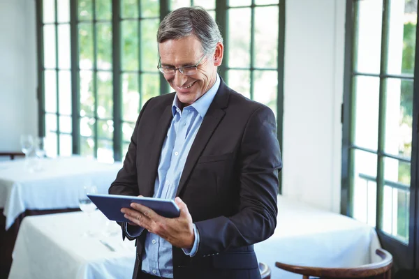 Homem de negócios sorrindo usando um tablet — Fotografia de Stock