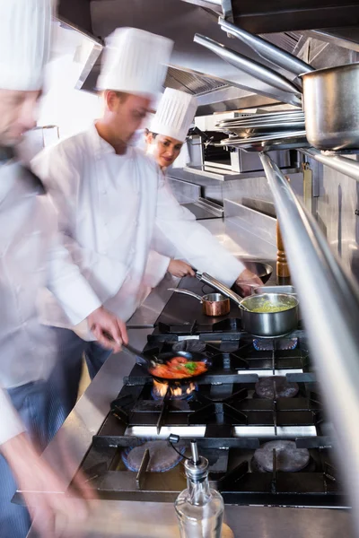 Chefs preparing food in the kitchen — Stock Photo, Image