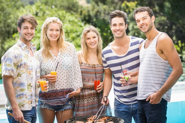 Group of friends preparing barbecue near pool — Stock Photo, Image
