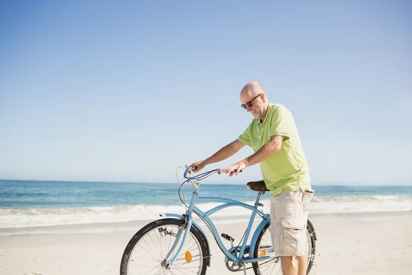 Smiling senior man with bike — Stock Photo, Image