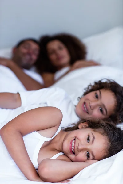 Brother and sister lying on bed — Stock Photo, Image