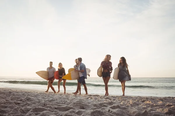 Felices amigos caminando con tablas de surf — Foto de Stock