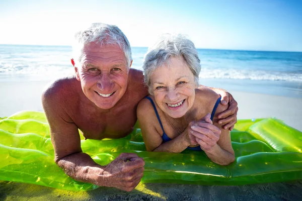 Senior couple lying on air mattress — Stock Photo, Image