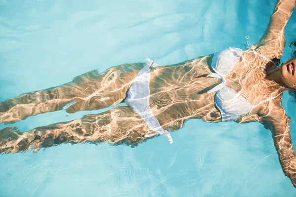Schöne Frau im weißen Bikini schwimmend — Stockfoto