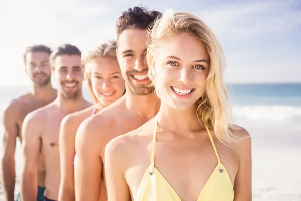 Smiling friends standing in line — Stock Photo, Image