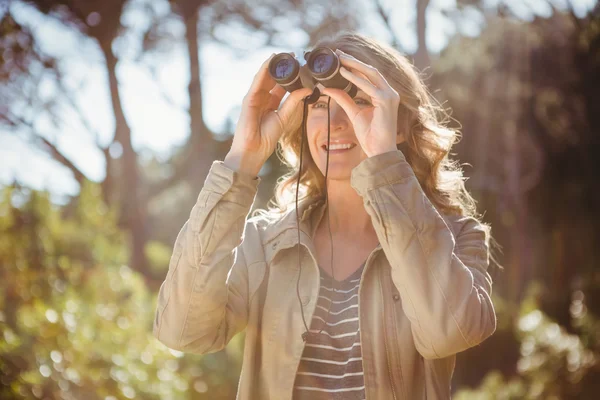 Woman using binoculars — Stock Photo, Image