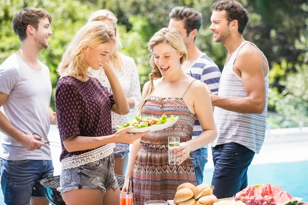 Friends preparing for outdoors barbecue party — Stock Photo, Image