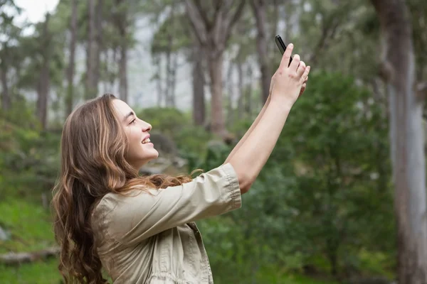 Lächelnde Frau macht Selfies — Stockfoto