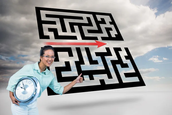 Delighted businesswoman holding a clock — Stock Photo, Image