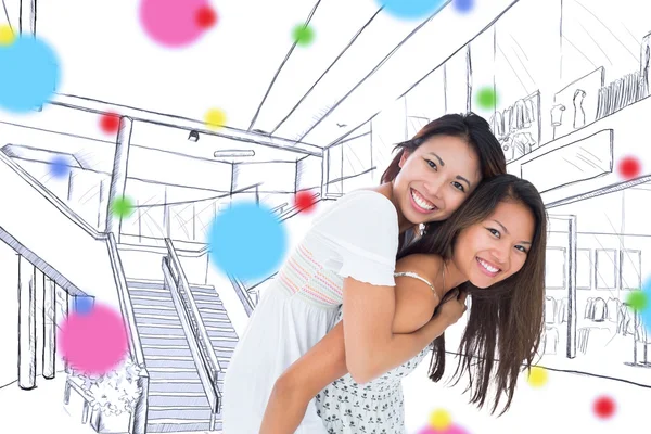 Smiling asian woman giving her sister a piggyback ride — Stock Photo, Image