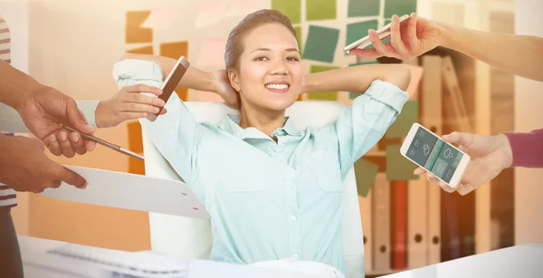 Manos sosteniendo dispositivos contra la mujer de negocios —  Fotos de Stock