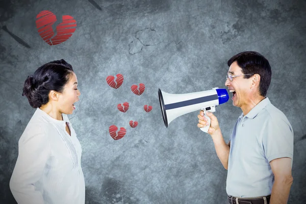 Composite image of man shouting at his partner through megaphone — Stock Photo, Image