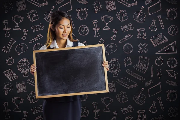 Businesswoman holding a blackboard — Stock Photo, Image