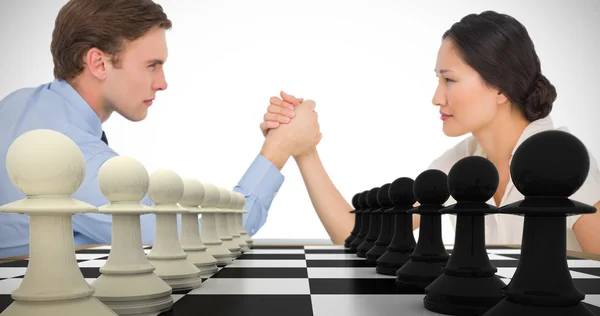 Business couple arm wrestling — Stock Photo, Image