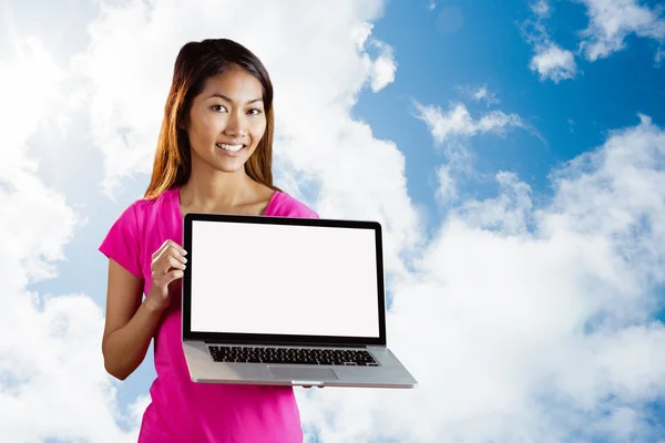 Smiling asian woman holding computer — Stock Photo, Image
