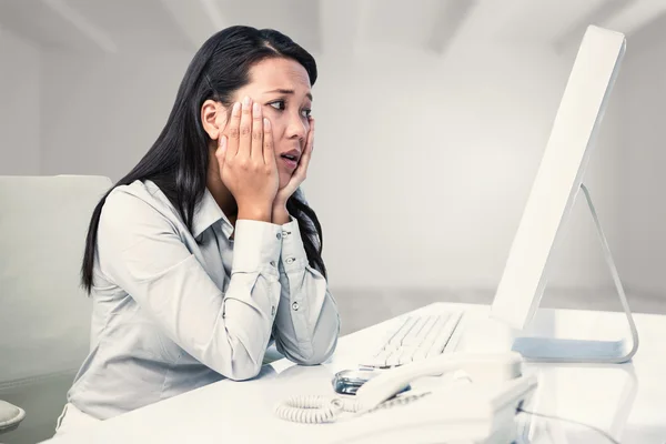Exhausted businesswoman with hands on face — Stock Photo, Image