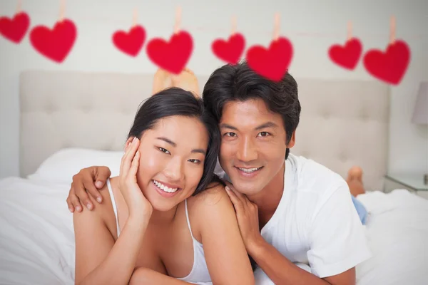 Happy couple lying on bed — Stock Photo, Image