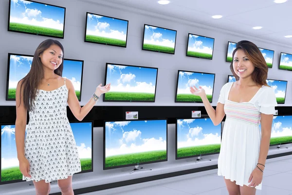 Composite image of two pretty asian women presenting — Stock Photo, Image