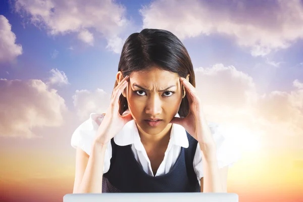 Nervous businesswoman using a laptop — Stock Photo, Image