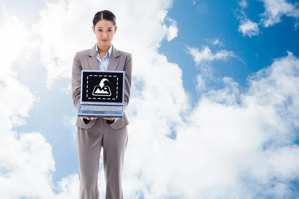 Portrait of a businesswoman showing a notebook — Stock Photo, Image