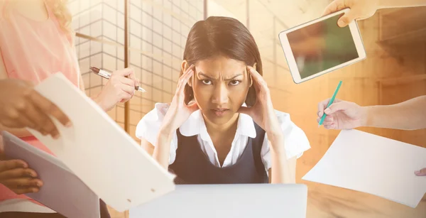 Hands holding devices against businesswoman — Stock Photo, Image