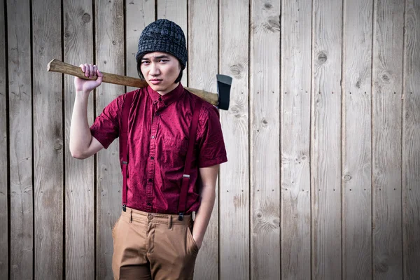 Composite image of hipster holding a axe — Stock Photo, Image