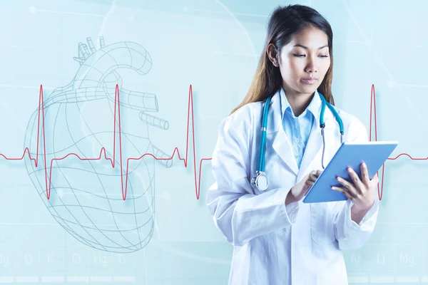 Asian doctor using tablet — Stock Photo, Image