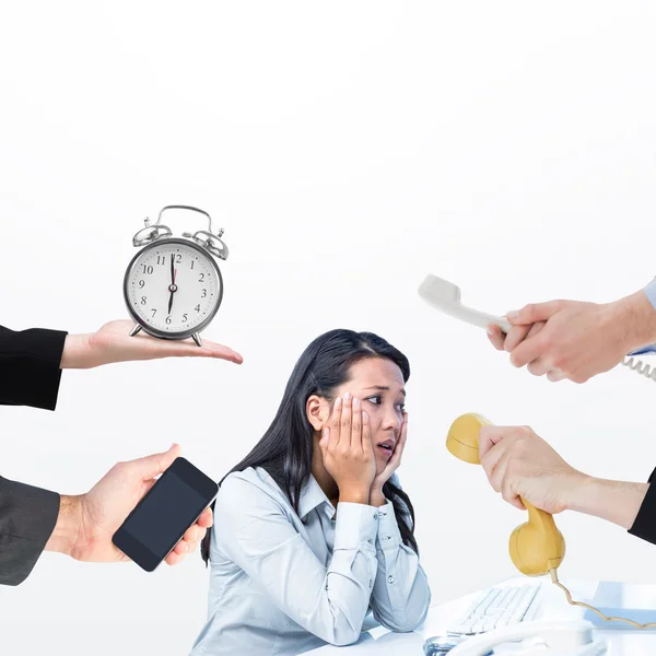 Hands holding objects against businesswoman — Stock Photo, Image