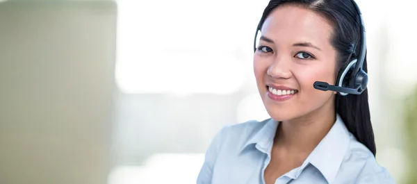 Smiling businesswoman using headset — Stock Photo, Image