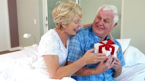 Senior woman offering present to husband — Stock Video