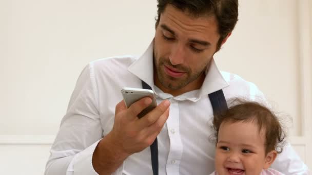 Vader met baby en praten over de telefoon — Stockvideo