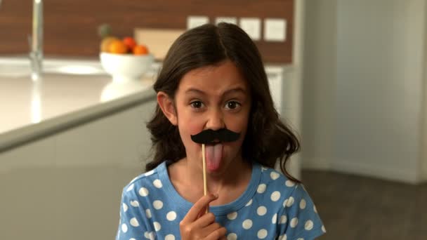 Daughter with fake mustaches making faces — Stock Video