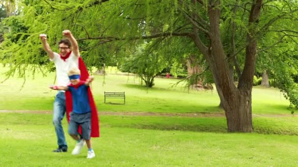 Father and son pretending to be superhero — Stock Video