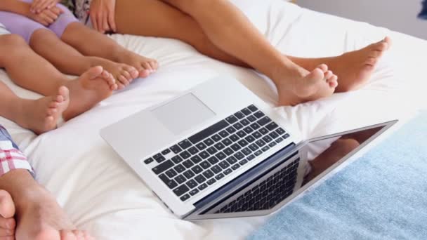Keluarga menggunakan laptop di tempat tidur — Stok Video