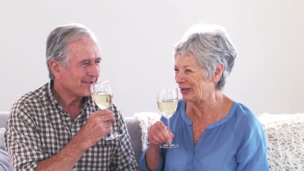 Bonito casal maduro brindar com vinho na sala de estar — Vídeo de Stock